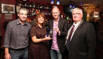 From left: Padraig and Geraldine Killoran, proprietors of Kelly’s Bar in Strandhill, Co Sligo, who won the From left: Padraig and Geraldine Killoran, proprietors of Kelly’s Bar in Strandhill, Co Sligo, who won the 2010 Best Local award, receiving their award from NewsTalk’s Sean Moncrief with VFI President Gerry Mellett in their bar recently.