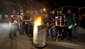 Members of the Irish Farmers Association, keep warm around a fire while holding a 24 hour protest outside Meadow Meats in Rathdowney in County Laoise.