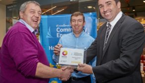 Brothers Rory and Raymond Hannon accept their Excellence Award from Dermot O'Toole of Maxol